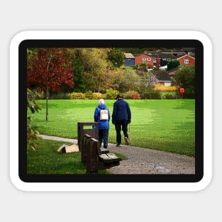 Old couple walking on a path in the park Sticker